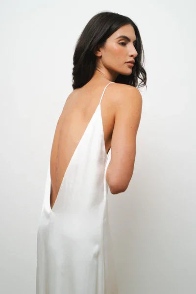 White satin maxi dress with low back and thin straps worn by model — Amara Grace | Endless UAE