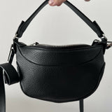 Black leather mini shoulder bag with textured finish held open to show interior — By Far | Endless UAE