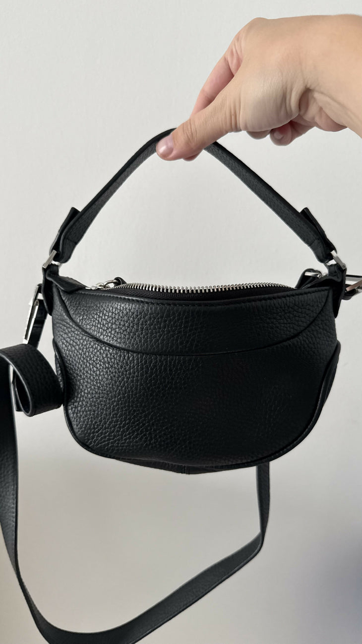 Black leather mini shoulder bag with textured finish held open to show interior — By Far | Endless UAE
