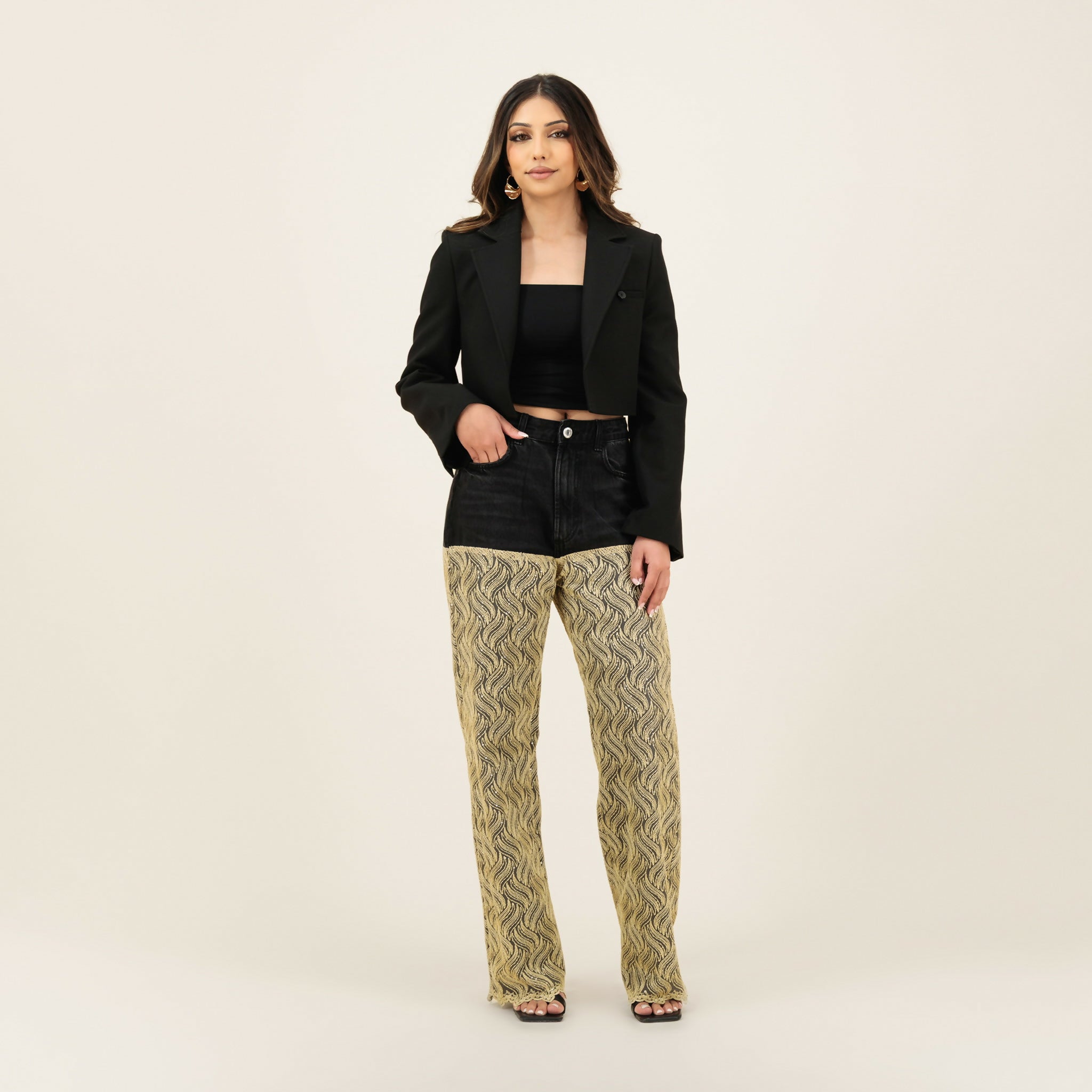 Black denim shorts with patterned beige wide-leg pants underneath, styled with a cropped black blazer — Quab | Endless UAE