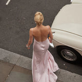 Elegant pink satin backless maxi dress with cowl back and flowing skirt, styled with vintage car — By Keara | Endless UAE