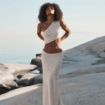 Ivory sequin one-shoulder crop top and maxi skirt set worn on coastal rocks at sunset — Label Loft London | Endless UAE