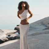 Ivory sequin one-shoulder crop top and maxi skirt set worn on coastal rocks at sunset — Label Loft London | Endless UAE