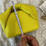 Hand measuring lime yellow padded leather Twister Nano crossbody bag with tape measure — JW Anderson | Endless UAE