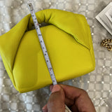 Hand measuring lime yellow padded leather Twister Nano crossbody bag with tape measure — JW Anderson | Endless UAE