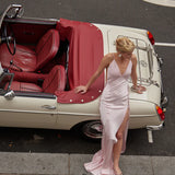 Elegant pink backless maxi dress with high slit and halter neckline styled with vintage convertible car — By Keara | Endless UAE