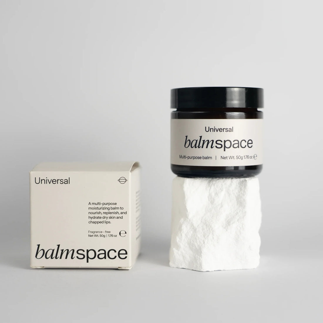 Multi-purpose moisturizing balm jar with packaging on white stone pedestal — Balm Space | Endless UAE