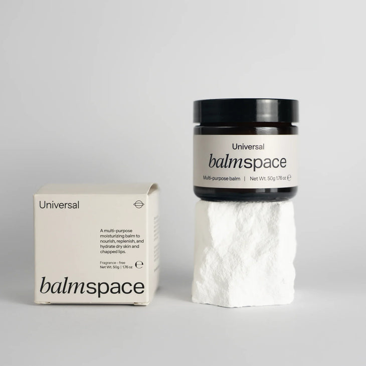 Multi-purpose moisturizing balm jar with packaging on white stone pedestal — Balm Space | Endless UAE