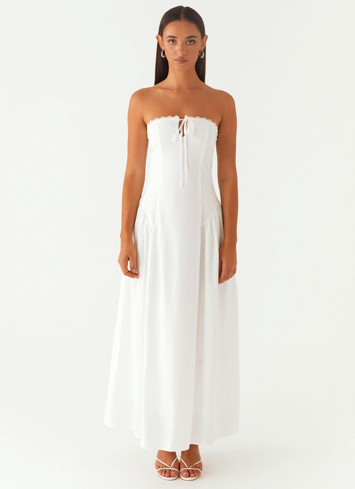 Woman wearing white strapless maxi dress with tie detail — Peppermayo | Endless UAE