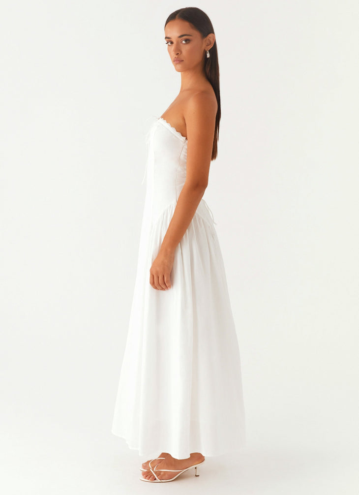 Woman wearing white strapless maxi dress with tie detail — Peppermayo | Endless UAE