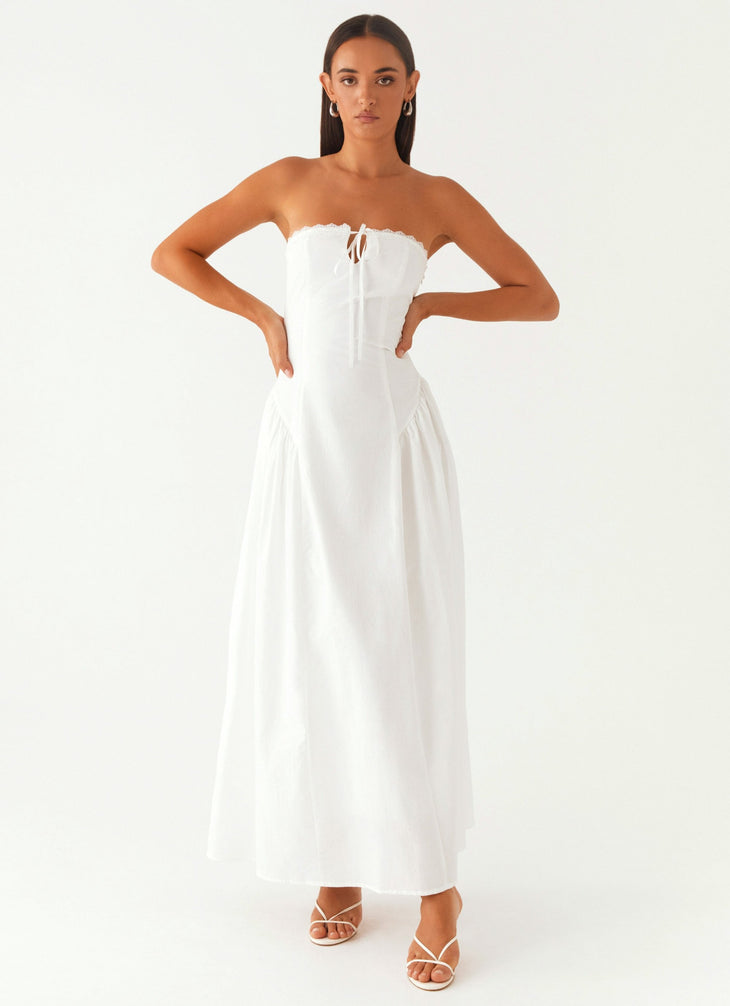 Woman wearing white strapless maxi dress with tie detail — Peppermayo | Endless UAE