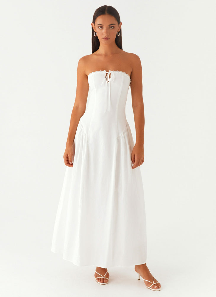 Woman wearing white strapless maxi dress with tie detail — Peppermayo | Endless UAE