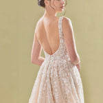 Elegant blush pink A-line bridal gown with deep V-back, delicate lace appliqués and flowing tulle skirt — Teresa Atelier | Endless UAE