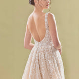Elegant blush pink A-line bridal gown with deep V-back, delicate lace appliqués and flowing tulle skirt — Teresa Atelier | Endless UAE