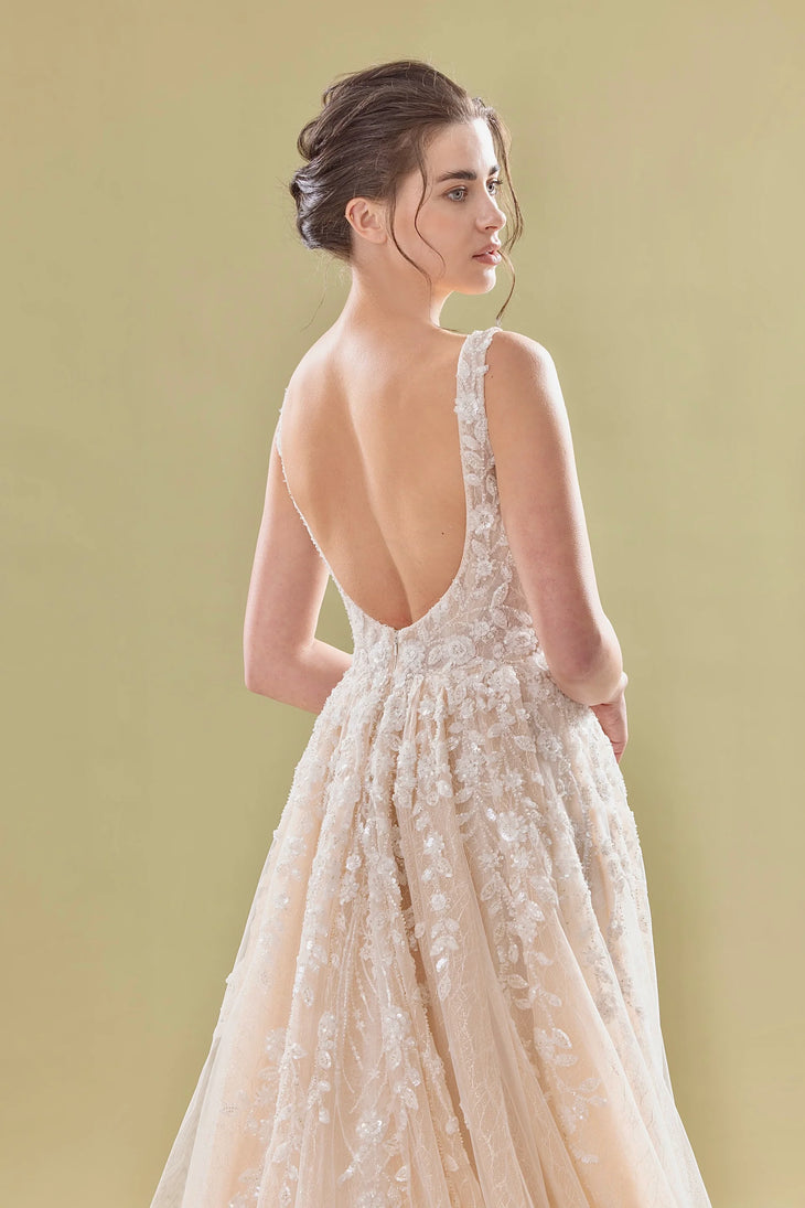 Elegant blush pink A-line bridal gown with deep V-back, delicate lace appliqués and flowing tulle skirt — Teresa Atelier | Endless UAE