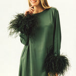 Woman wearing forest green satin midi dress with black feather cuffs and gold sandals — Sleeper | Endless UAE