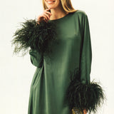 Woman wearing forest green satin midi dress with black feather cuffs and gold sandals — Sleeper | Endless UAE