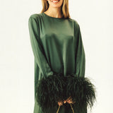 Woman wearing forest green satin midi dress with black feather cuffs and gold sandals — Sleeper | Endless UAE