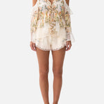 Floral ruffle cold-shoulder blouse with cream high-waisted scalloped shorts — Camilla | Endless UAE
