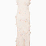 Woman modeling a cream floral ruffled maxi dress with delicate pastel details — LoveShackFancy | Endless UAE