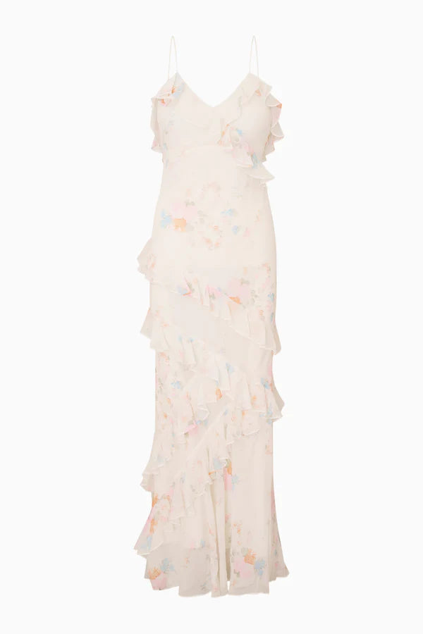 Woman modeling a cream floral ruffled maxi dress with delicate pastel details — LoveShackFancy | Endless UAE