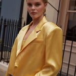 Model wearing yellow cropped silk blazer with notch lapels and blue jeans — By Keara | Endless UAE