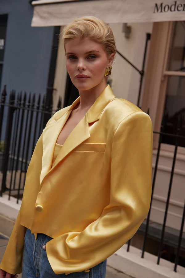 Model wearing yellow cropped silk blazer with notch lapels and blue jeans — By Keara | Endless UAE