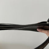 Black crocodile embossed leather shoulder bag held in hand against white background — By Far | Endless UAE