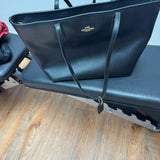Black leather tote bag with dual handles and Coach branding — Coach | Endless UAE
