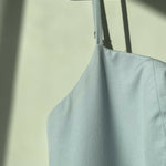 Woman wearing light blue sleeveless midi dress with corset top and full skirt — Endless | Endless UAE