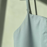 Woman wearing light blue sleeveless midi dress with corset top and full skirt — Endless | Endless UAE