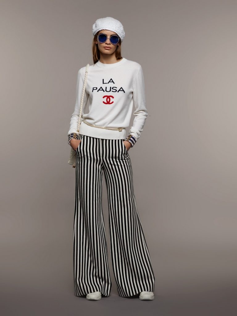 Model wearing Chanel Cruise 2019 striped wide leg trousers with white sweatshirt — Chanel | Endless UAE