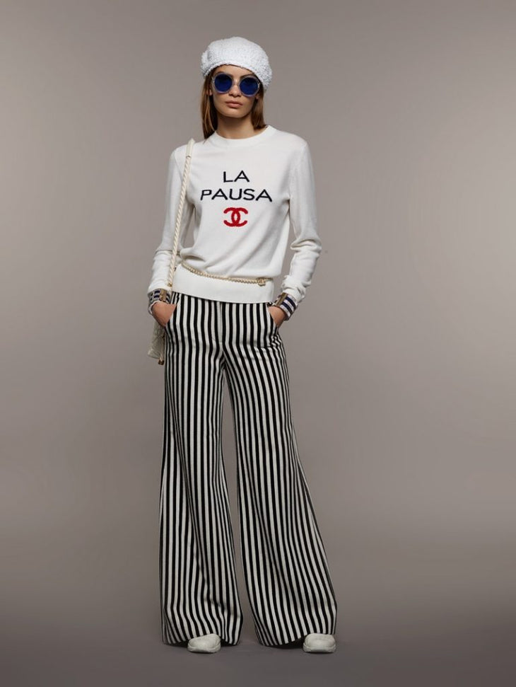 Model wearing Chanel Cruise 2019 striped wide leg trousers with white sweatshirt — Chanel | Endless UAE