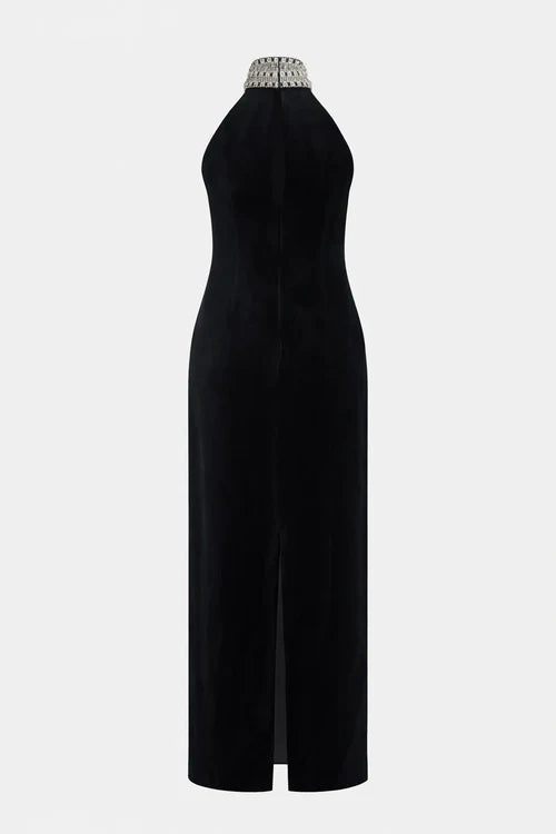 Woman wearing black halter neck velvet evening dress standing in front of historic building — COPURS | Endless UAE