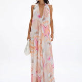 Woman wearing pastel pink and peach Bohemia Maxi Dress with abstract star print — Cin Cin | Endless UAE