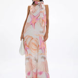 Woman wearing pastel pink and peach Bohemia Maxi Dress with abstract star print — Cin Cin | Endless UAE