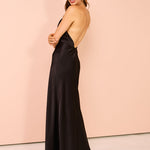 Black satin halter maxi dress with chain neck detail and open back worn by model — Shona Joy | Endless UAE