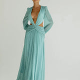Woman wearing a flowing light blue wrap dress with long sleeves and cutout waist detail — Anne Louise Boutique | Endless UAE