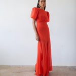Woman wearing red crinkle chiffon maxi dress with puff sleeves — De La Vali | Endless UAE