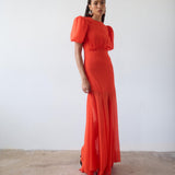 Woman wearing red crinkle chiffon maxi dress with puff sleeves — De La Vali | Endless UAE