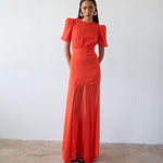 Woman wearing red crinkle chiffon maxi dress with puff sleeves — De La Vali | Endless UAE