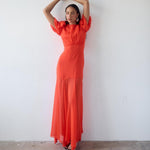 Woman wearing red crinkle chiffon maxi dress with puff sleeves — De La Vali | Endless UAE