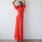Woman wearing red crinkle chiffon maxi dress with puff sleeves — De La Vali | Endless UAE