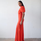 Woman wearing red crinkle chiffon maxi dress with puff sleeves — De La Vali | Endless UAE