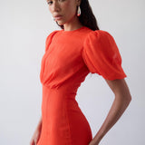 Woman wearing red crinkle chiffon maxi dress with puff sleeves — De La Vali | Endless UAE