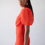 Woman wearing red crinkle chiffon maxi dress with puff sleeves — De La Vali | Endless UAE