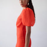Woman wearing red crinkle chiffon maxi dress with puff sleeves — De La Vali | Endless UAE