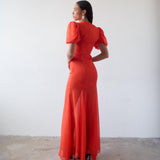 Woman wearing red crinkle chiffon maxi dress with puff sleeves — De La Vali | Endless UAE