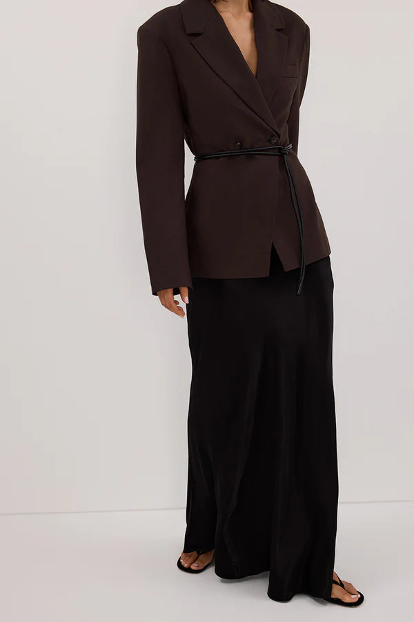 Woman wearing black sleeveless tank top and black satin maxi skirt — Dissh | Endless UAE