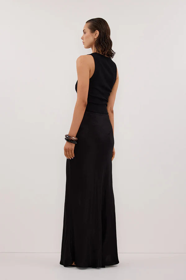 Woman wearing black sleeveless tank top and black satin maxi skirt — Dissh | Endless UAE